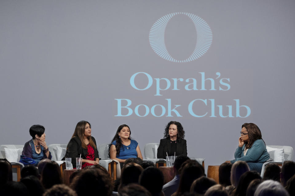 In this Feb. 13, 2020 photo released by Apple, Oprah Winfrey, right, hosts a taping of Oprah's Book Club with Jeanine Cummins, author of "American Dirt," second right, and panelists, from left, Esther J. Cepeda, Julissa Arce and Reyna Grande in Tuscon, Ariz. The two-part interview will begin streaming on Apple TV Plus at midnight ET on Friday, March 6. (Karen Ballard/Apple via AP)