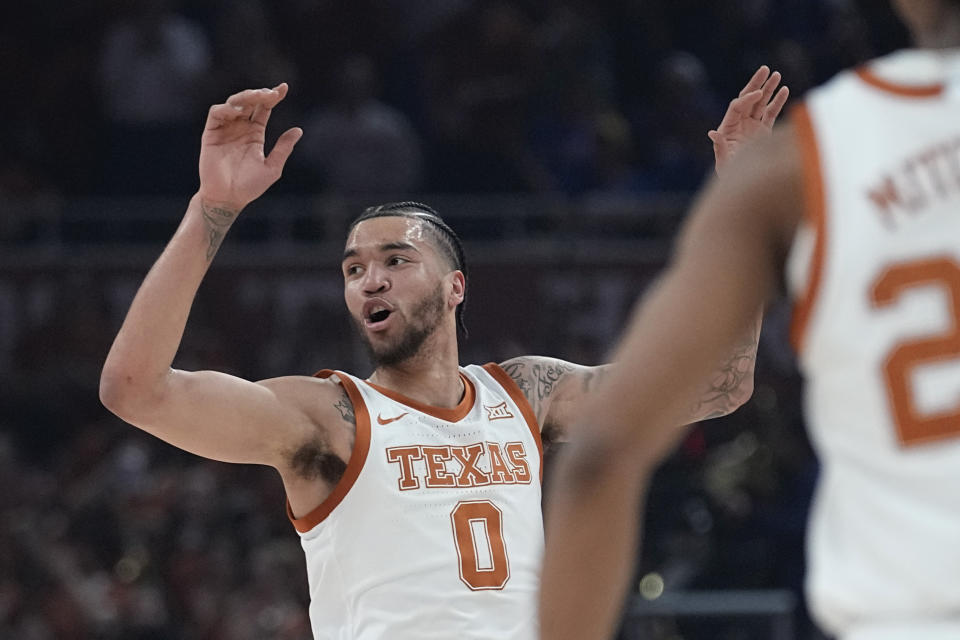 Texas forward Timmy Allen (0) celebrates a play against Kansas during the first half of an NCAA college basketball game in Austin, Texas, Saturday, March 4, 2023. (AP Photo/Eric Gay)