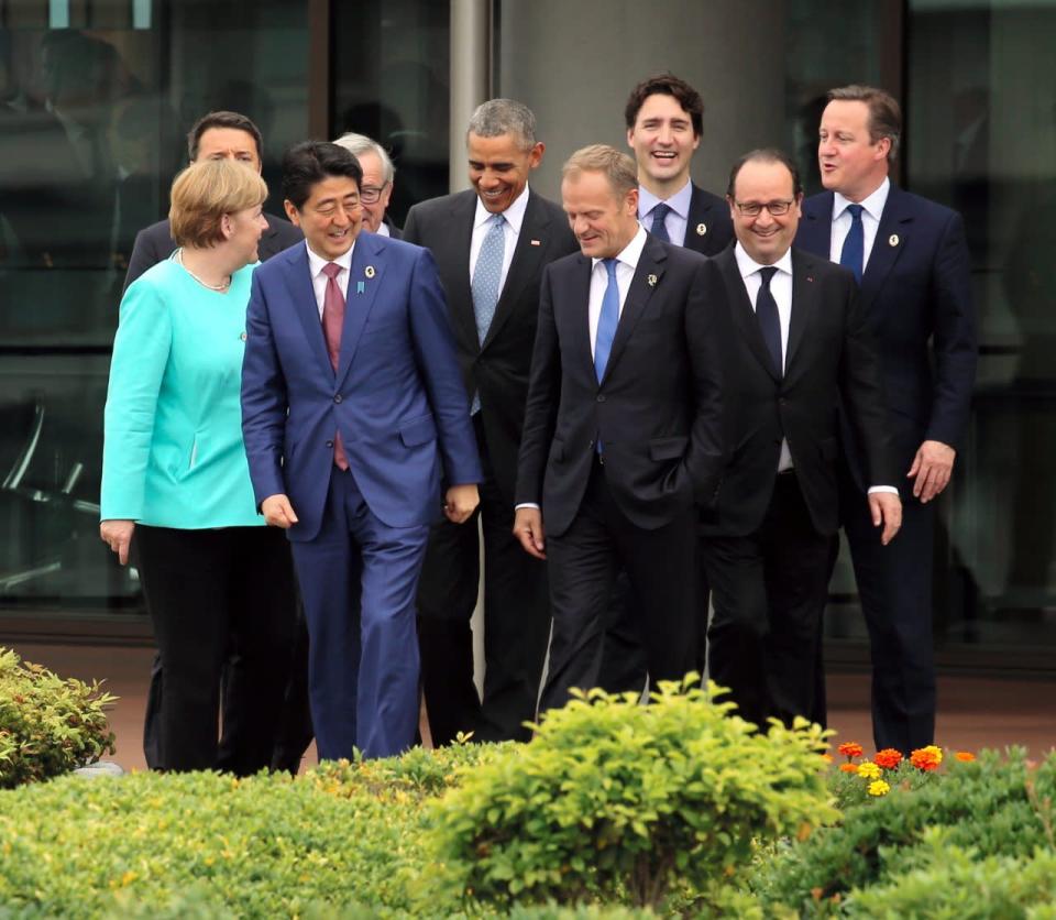 Japanese Prime Minister Shinzo Abe, second left, shares a laugh with other leaders of Group of Seven industrial nations, from left, German Chancellor Angela Merkel, Italian Prime Minister Matteo Renzi, left top behind Merkel, Abe, European Commission President Jean-Claude Juncker, U.S. President Barack Obama, European Council President Donald Tusk, Canadian Prime Minister Justin Trudeau, French President Francois Hollande and British Prime Minister David Cameron as they walk out to the family photo session on the first day of the G-7 summit meetings in Shima, Japan, Thursday, May 26, 2016. (Japan Pool via AP)