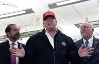 President Donald Trump speaks to members of the press as Health and Human Services Secretary Alex Azar, left, and CDC Director Robert Redfield, right, at the headquarters of the Centers for Disease Control and Prevention in Atlanta on Friday, March 6, 2020. (Hyosub Shin/Atlanta Journal-Constitution via AP)