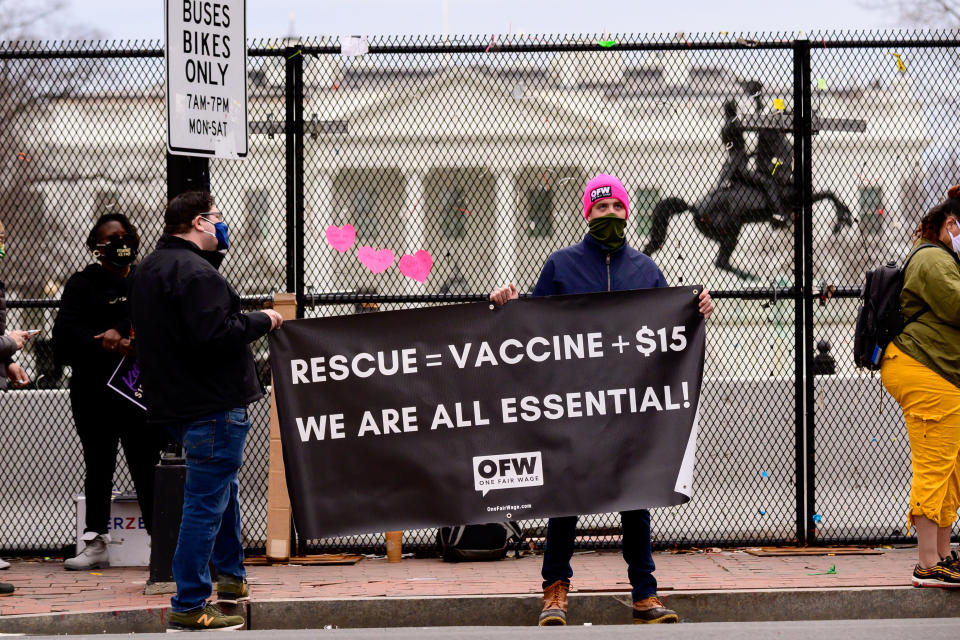 Protesters demand a federal $15-per-hour minimum wage near the White House in Washington, D.C., U.S., on Friday, Feb. 26, 2021. (Erin Scott/Bloomberg via Getty Images)