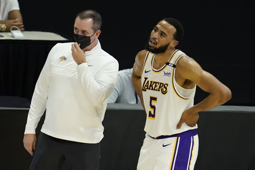 Los Angeles Lakers head coach Frank Vogel , left, stands next to Los Angeles Lakers guard Talen Horton-Tucker.
