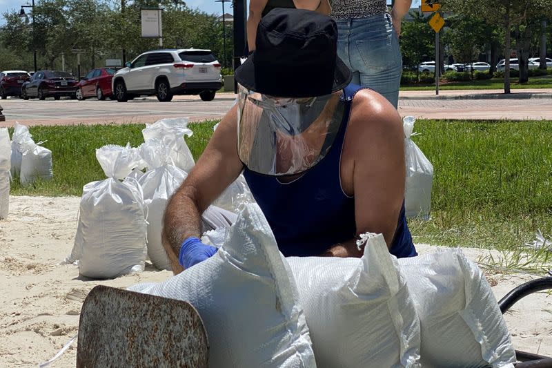 Residents fill and collect sand bags before the expected arrival of Hurricane Isaias in Doral