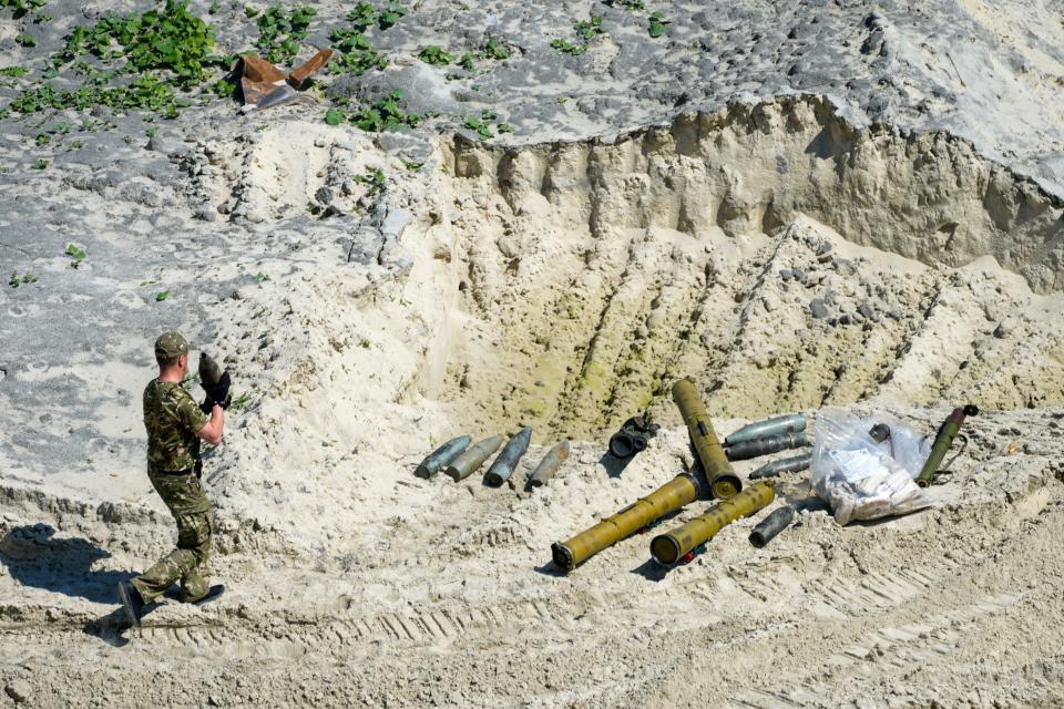 Ukrainian servicemen prepare unexploded Russian ammunition for destruction in the outskirts of Kyiv, Ukraine, Wednesday, June 1, 2022.