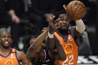 Los Angeles Clippers guard Terance Mann, left, and Phoenix Suns center Deandre Ayton reach for a rebound during the second half in Game 6 of the NBA basketball Western Conference Finals Wednesday, June 30, 2021, in Los Angeles. (AP Photo/Mark J. Terrill)