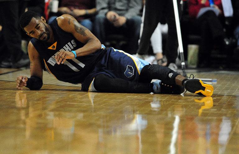 Mike Conley of the Memphis Grizzlies lies on the court after being injured during Game 3 of the Western Conference quarter-finals against the Portland Trail Blazers, during the NBA Playoffs, at the Moda Center in Portland, on April 25, 2015