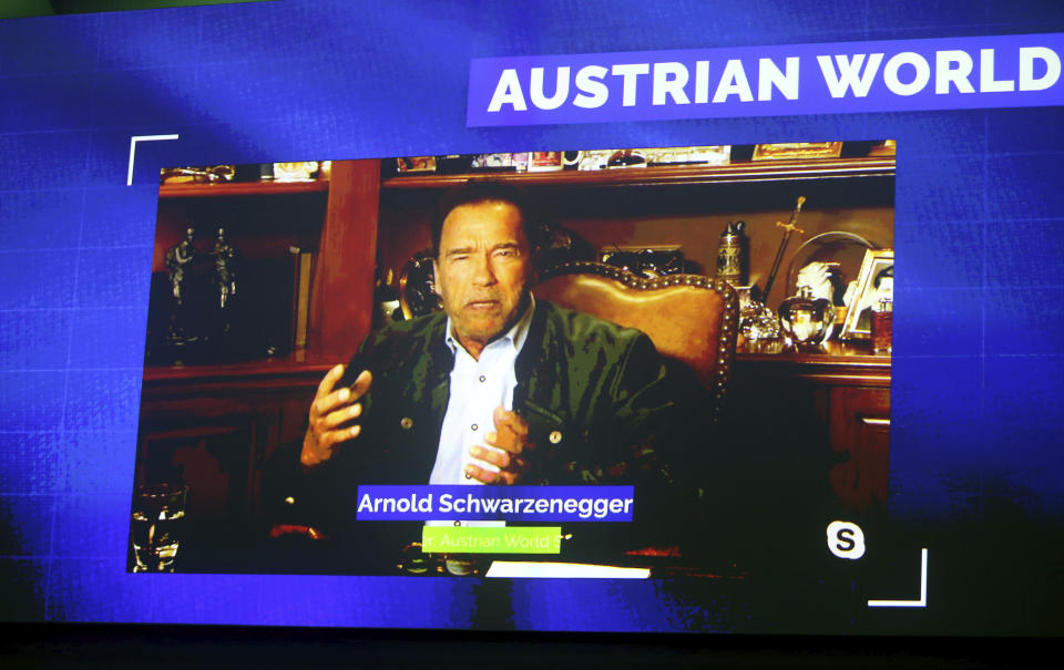 Former California Gov. Arnold Schwarzenegger is seen on a giant video screen during his online broadcasted speech as part of the 'Austrian World Summit' at the Spanish Riding School in Vienna, Austria, Thursday, Sept. 17, 2020. (AP Photo/Ronald Zak)