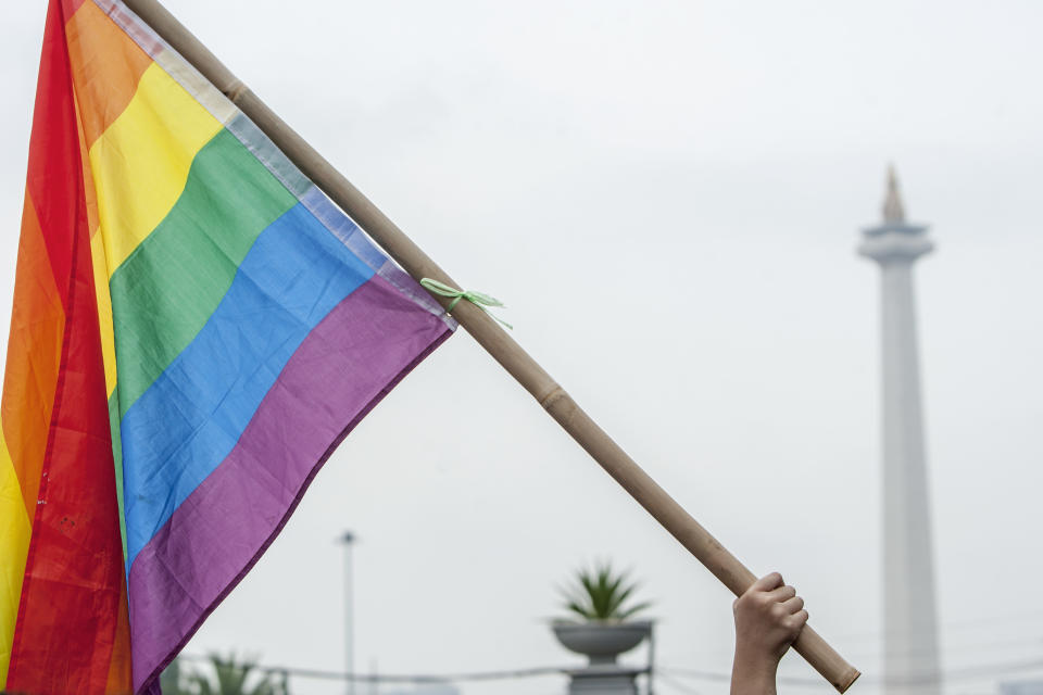 Protesters wave a rainbow flag during the Women's March on Jakarta, Indonesia on April 27, 2019. Large crowds are attending the rally to commemorate the Indonesian national heroine's birth day, Raden Ayu Kartini which falls on April 21. They demand the government to approve draft law on the Elimination of Sexual Violence. (Photo by Mas Agung Wilis/NurPhoto via Getty Images)