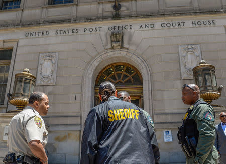 Sheriff Deputies stand in front of the courthouse on the first day of the Caesar Goodson trial in Baltimore, Maryland, U.S., June 9, 2016. REUTERS/Bryan Woolston