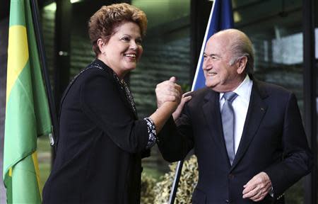 Brazil's President Dilma Rousseff (L) greets FIFA President Sepp Blatter during a visit at the FIFA headquarters in Zurich January 23, 2014. REUTERS/Thomas Hodel