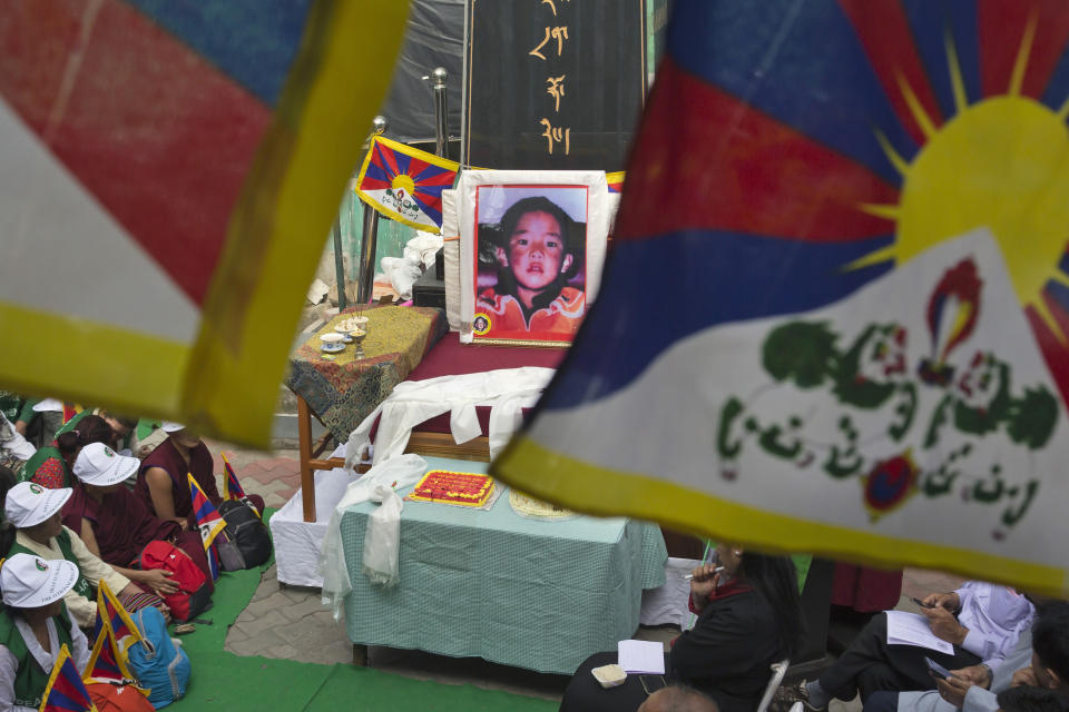 FILE - In this April 25, 2019, file photo, a portrait of the 11th Panchen Lama, Gendhun Choekyi Nyima, an important religious leader second only to the Dalai Lama in the Tibetan Buddhist hierarchy, is seen as exile Tibetans mark his birthday in Dharmsala, India. Tibet’s self-declared government-in-exile marked the 25th anniversary of the disappearance of the boy named as Tibetan Buddhism’s second highest figure by calling on China on Sunday, May 17, 2020 to account for his whereabouts. (AP Photo/Ashwini Bhatia, File)