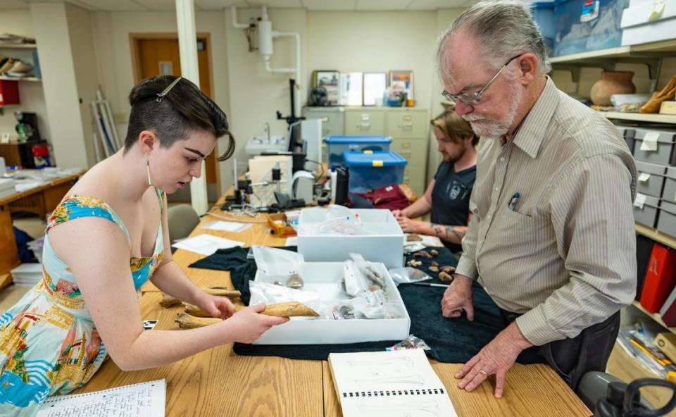Wichita State University anthropology professor Don Blakeslee helps graduate student Siofra Lynch catalog artifacts thought to be from the Native American town of Etzanoa near present day Arkansas City.
