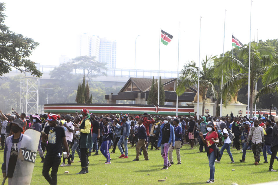 Protesters walk on the grounds of the Kenyan parliament during a protest over proposed tax hikes in a finance bill in downtown Nairobi, Kenya, Tuesday, June 25, 2024. (AP Photo/Andrew Kasuku)