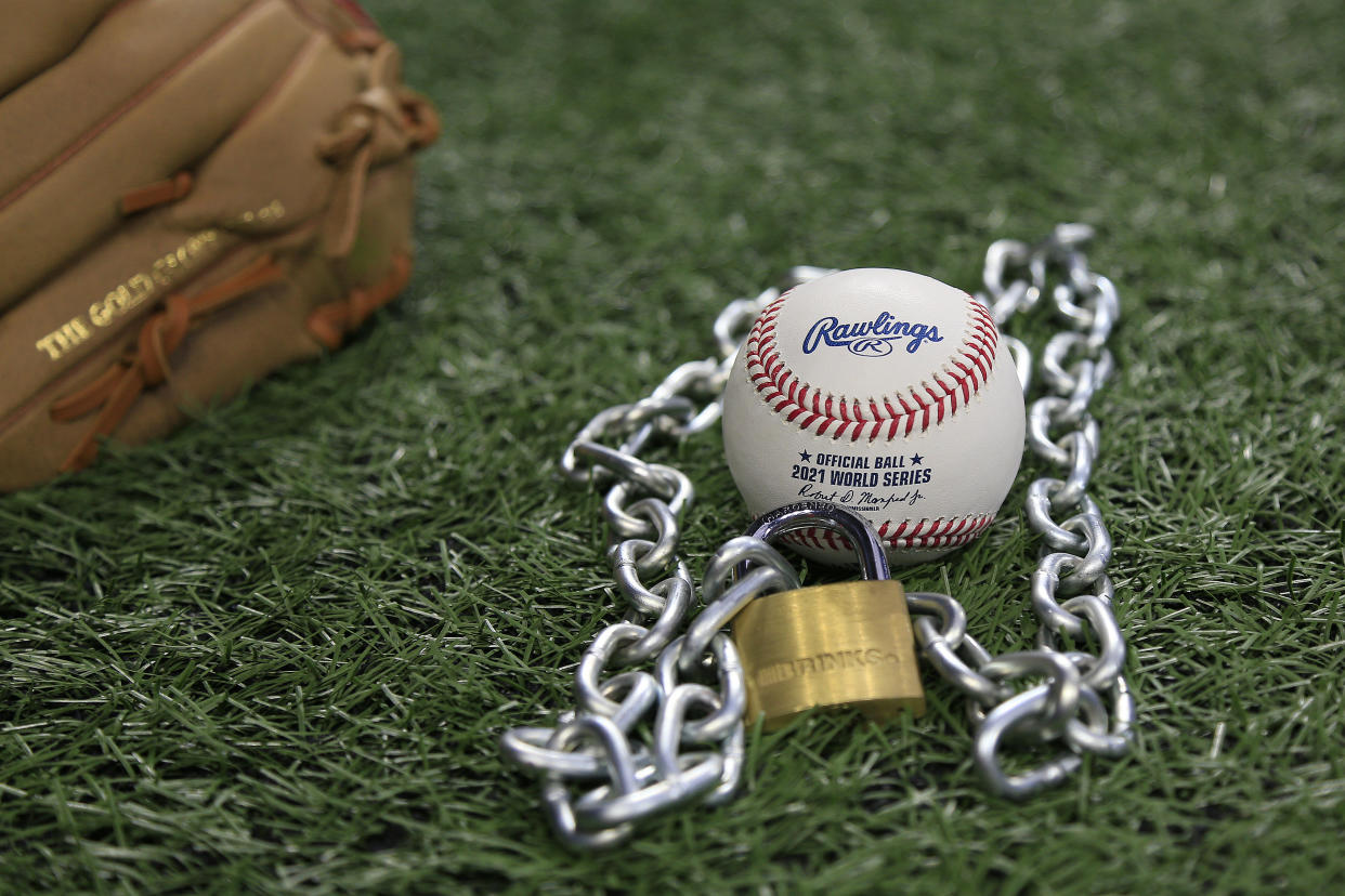 Atlanta, GA - January 09:  An Official Rawlings Major League baseball sits with a glove, lock and chain to represent the lockout between Major League Baseball (MLB) and the Major League Baseball Players Association (MLBPA) on January 09, 2022 in Atlanta, Georgia.   (Photo by David J. Griffin/Icon Sportswire via Getty Images)