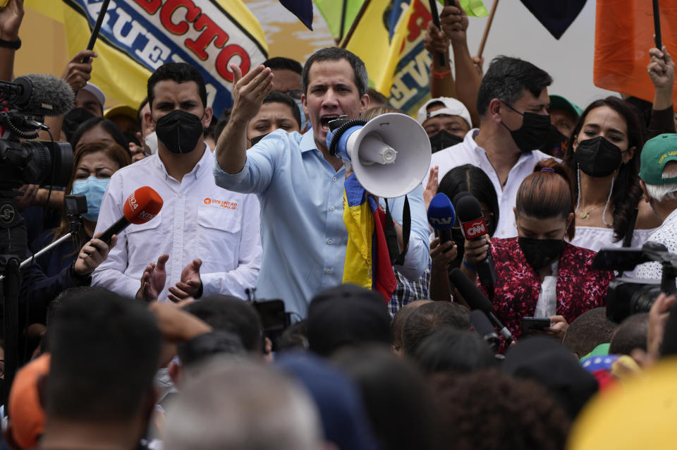 Opposition leader Juan Guaido, center, speaks to supporters during a gathering to mark Youth Day, in Caracas, Venezuela, Saturday, Feb. 12, 2022. The annual holiday commemorates youths who accompanied heroes in the battle for Venezuela's independence. (AP Photo/Ariana Cubillos)