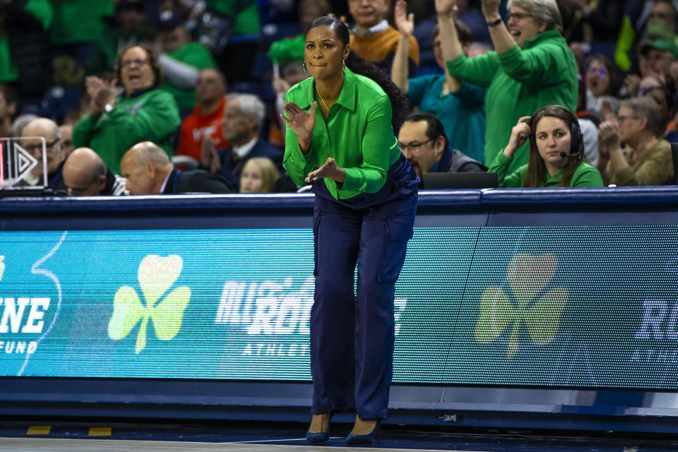 Notre Dame head coach Niele Ivey, center, claps from the sideline during the second half of an NCAA college basketball game against Virginia Tech, Thursday, Feb. 29, 2024, in South Bend, Ind. (AP Photo/Michael Caterina)