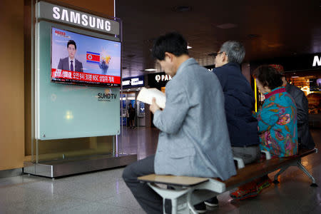 People watch a TV broadcasting a news report on North Korea's failed missile launch from its east coast, at a railway station in Seoul, South Korea, April 16, 2017. REUTERS/Kim Hong-Ji