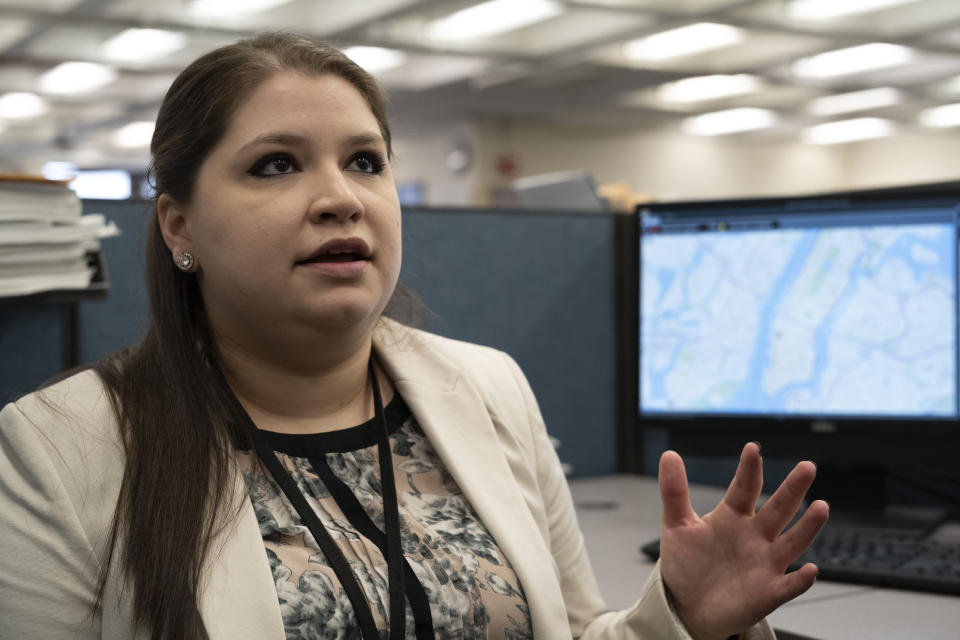 In this Feb. 11, 2019 photo, Rebecca Shutt, who works in the New York Police Department's Office of Crime Control Strategies, speaks in New York. Shutt utilizes a software called Patternizr, which allows crime analysts to compare robbery, larceny and theft incidents to the millions of crimes logged in the NYPD's database, aiding their hunt for crime patterns. It's much faster than the old method, which involved analysts sifting through reports and racking their brains for similar incidents. (AP Photo/Mark Lennihan)