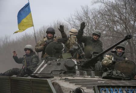 Members of the Ukrainian armed forces ride an armoured personnel carrier near Debaltseve, eastern Ukraine, February 20, 2015. REUTERS/Gleb Garanich