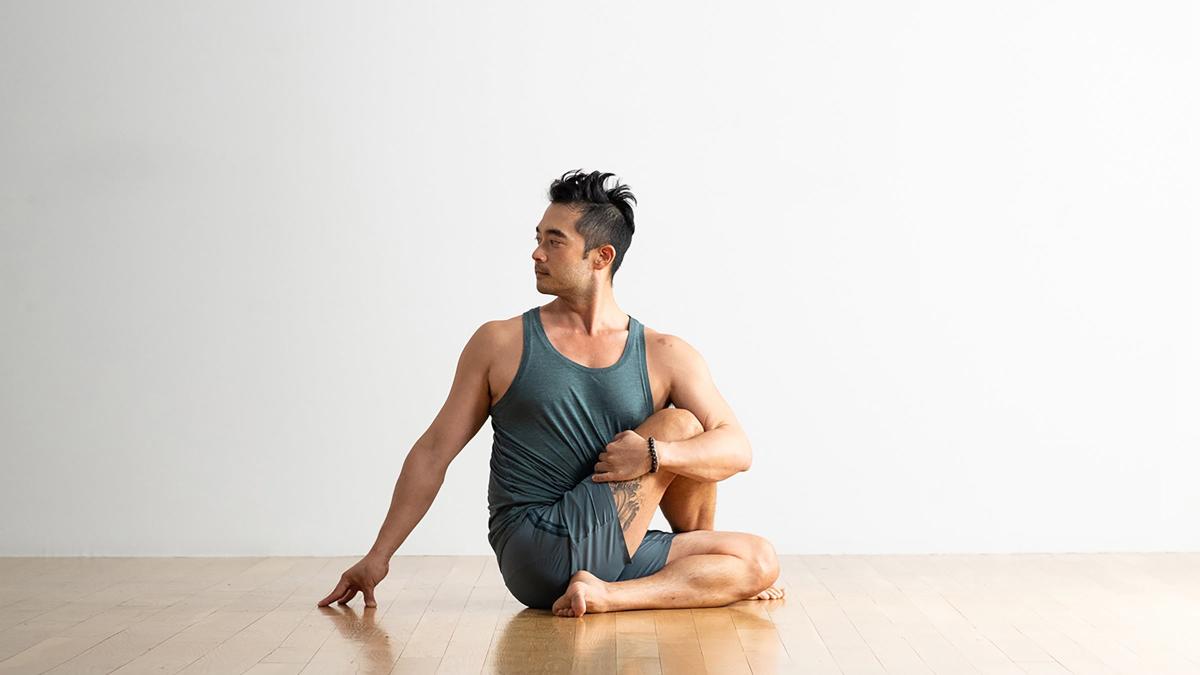 Man standing in yoga position Athletic man practicing yoga in vasisthasana  side plank variation