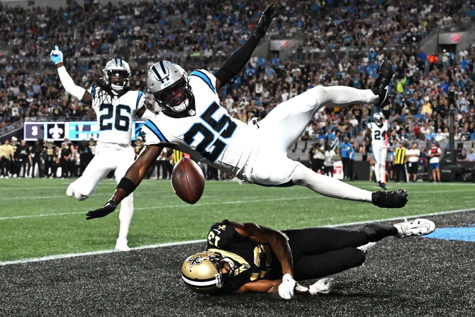 CHARLOTTE, NORTH CAROLINA - SEPTEMBER 18: Xavier Woods #25 of the Carolina Panthers breaks up a pass in the end zone intended for Michael Thomas #13 of the New Orleans Saints during the second quarter in the game at Bank of America Stadium on September 18, 2023 in Charlotte, North Carolina. (Photo by Grant Halverson/Getty Images)