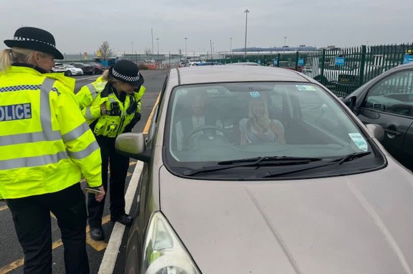 Two Birmingham Airport officers check out a car with 'suspicious people' that had 'not left their car for some time' back in March, who turned out to be seat covers