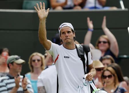 Tommy Haas of Germany waves to fans after losing his match against Milos Raonic of Canada at the Wimbledon Tennis Championships in London, July 1, 2015. REUTERS/Suzanne Plunkett