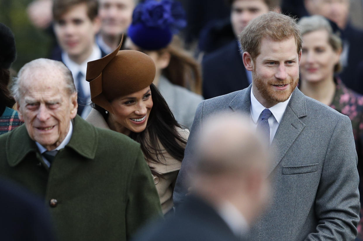 (L-R) Britain's Prince Philip, Duke of Edinburgh, US actress and fiancee of Britain's Prince Harry Meghan Markle and Britain's Prince Harry (R) arrive to attend the Royal Family's traditional Christmas Day church service at St Mary Magdalene Church in Sandringham, Norfolk, eastern England, on December 25, 2017. / AFP PHOTO / Adrian DENNIS        (Photo credit should read ADRIAN DENNIS/AFP via Getty Images)