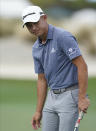 Collin Morikawa of the United States, reacts after missing a putt on the first hole during day three of the Hero World Challenge PGA Tour at the Albany Golf Club, in New Providence, Bahamas, Saturday, Dec. 4, 2021. (AP Photo/Fernando Llano)