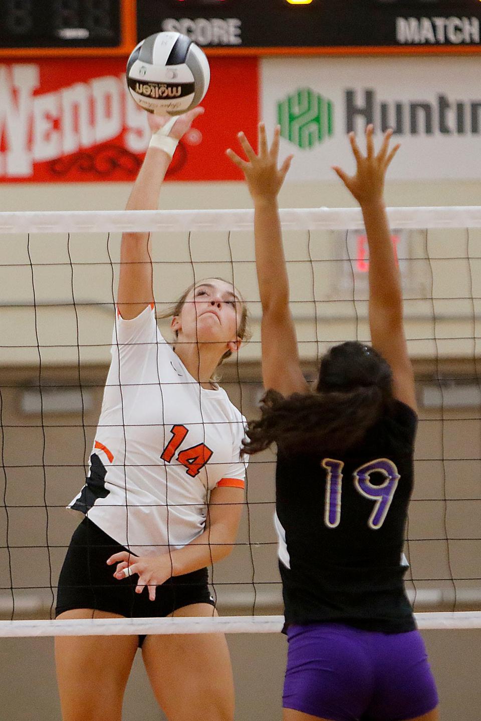 Ashland High School's Elysia Zehner (14) hits a shot at the net against Lexington High School's JazBee Mack (19) during high school volleyball action Tuesday, Aug. 31, 2021. TOM E. PUSKAR/TIMES-GAZETTE.COM