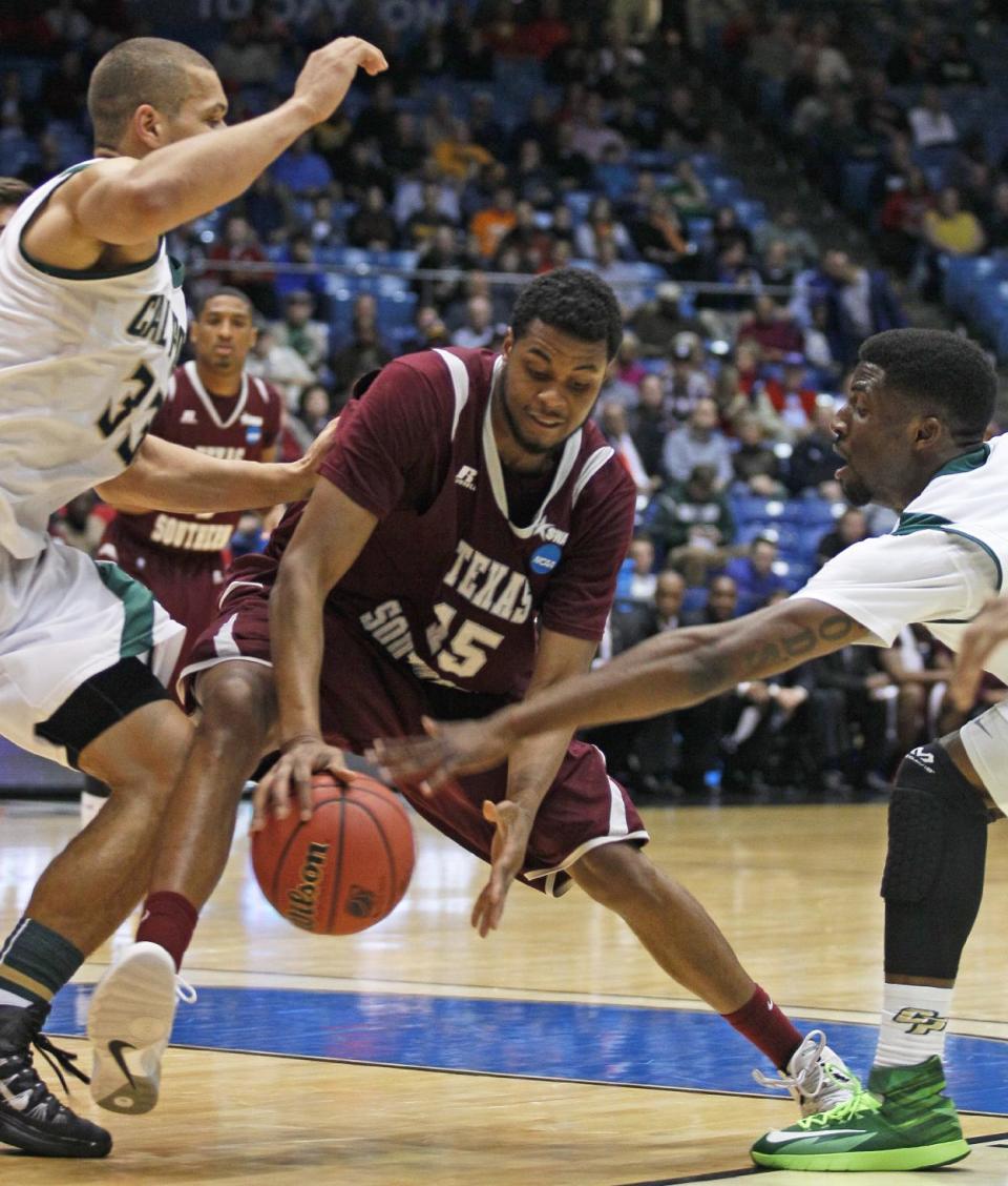 Texas Southern forward D'Angelo Scott (15) drives between Cal Poly forward Chris Eversley (33) and guard Dave Nwaba in the first half of a first-round game of the NCAA college basketball tournament on Wednesday, March 19, 2014, in Dayton, Ohio. (AP Photo/Skip Peterson)