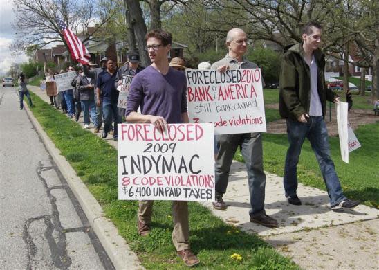 Members of Occupy Cincinnati march through the Price Hill neighborhood to protest against the banking industry over the home foreclosures throughout Cincinnati and the rest of the country during an Occupy Cincinnati rally an march in Cincinnati, Ohio, March 24, 2012. Occupy activists across America say they have found a cause that represents an issue for the "99 percent" and embodies the movement's anti-Wall Street message: helping struggling homeowners fight foreclosure and eviction. Picture taken March 24, 2012.