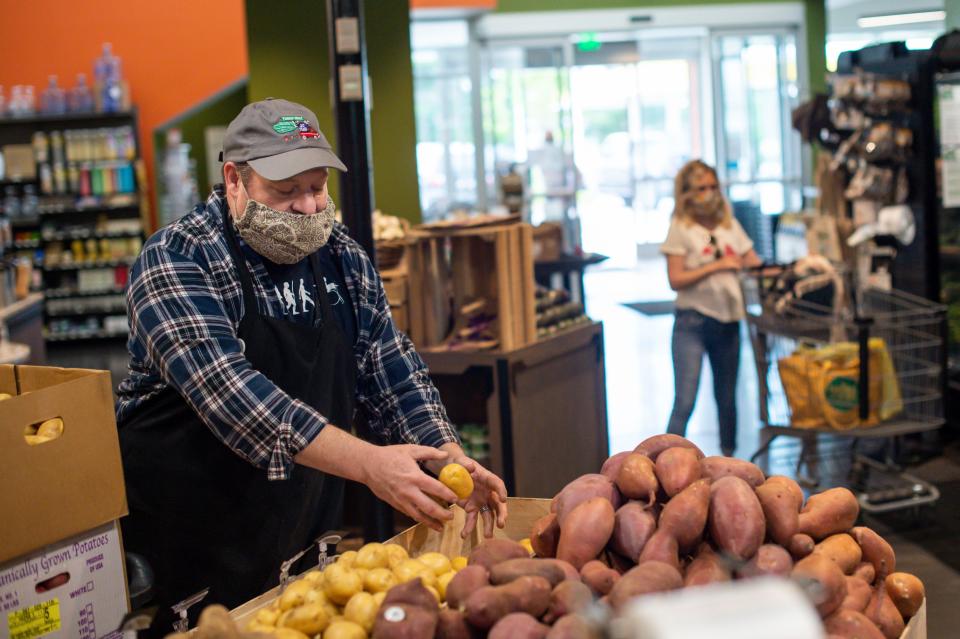 Turnip Truck employee Ross Standridge stocks the potato display at the West Nashville Turnip Truck store on Tuesday, May 11, 2021 in Nashville, Tenn. Turnip Truck is celebrating 20 years after opening in East Nashville in 2001 as an all-natural, locally sourced grocery store. Now, there are three locations for the store across Nashville.