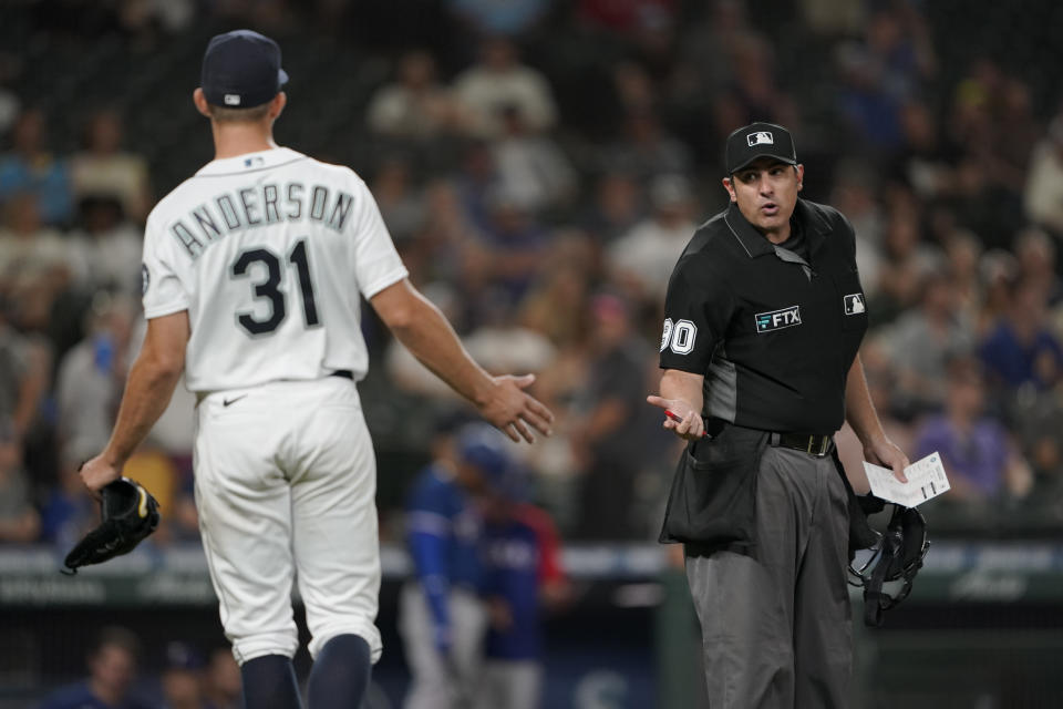 Seattle Mariners starting pitcher Tyler Anderson (31) argues with home plate umpire Mark Ripperger as Anderson leaves the field during a pitching change in the sixth inning of the team's baseball game against the Texas Rangers, Wednesday, Aug. 11, 2021, in Seattle. Anderson was called for a balk in the inning. (AP Photo/Ted S. Warren)