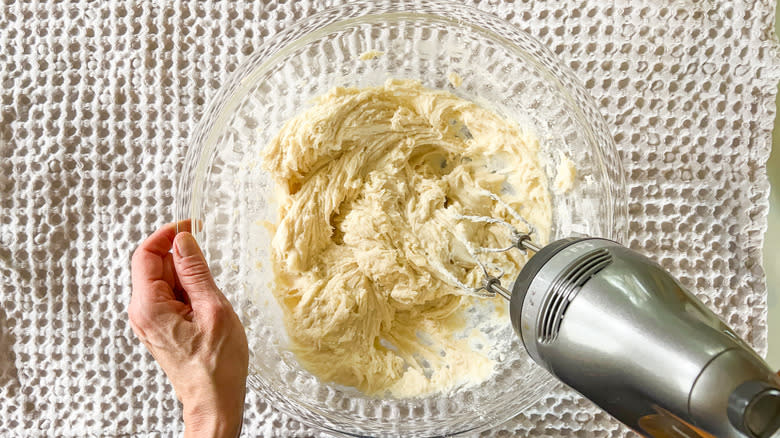 Mixing bright and sunny lemon lavender cake batter with hand mixer