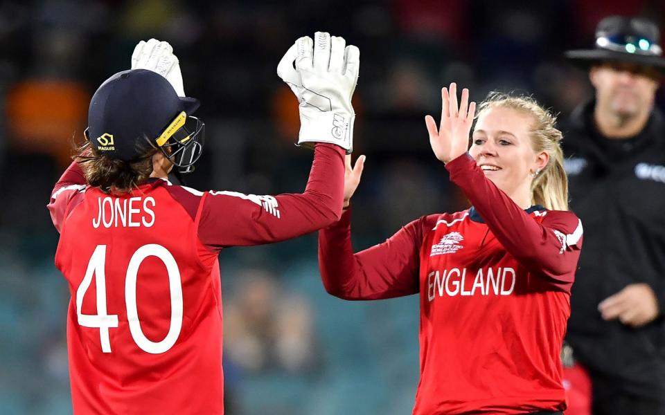 England's Sarah Glenn (R) celebrates the dismissal of Pakistan's Javeria Khan with teammate Amy Jones during the Twenty20 women's World Cup cricket match between Pakistan and England in Canberra on February 28, 2020 - AFP