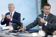 US President Joe Biden, left, listens as France's President Emmanuel Macron speaks during a working session at the G7 summit in Carbis Bay, Cornwall, England, Saturday, June 12, 2021. (Brendan Smialowski/Pool Photo via AP)