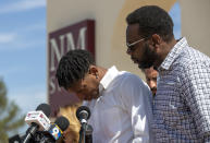 Former New Mexico State NCAA college basketball player Deuce Benjamin, left, is comforted by his father William Benjamin as he breaks down while speaking at a news conference in Las Cruces, N.M., Wednesday, May 3, 2023. Benjamin and former Aggie player Shak Odunewu discussed the lawsuit they filed alleging teammates ganged up and sexually assaulted them multiple times, while their coaches and others at the school didn't act when confronted with the allegations. (AP Photo/Andres Leighton)