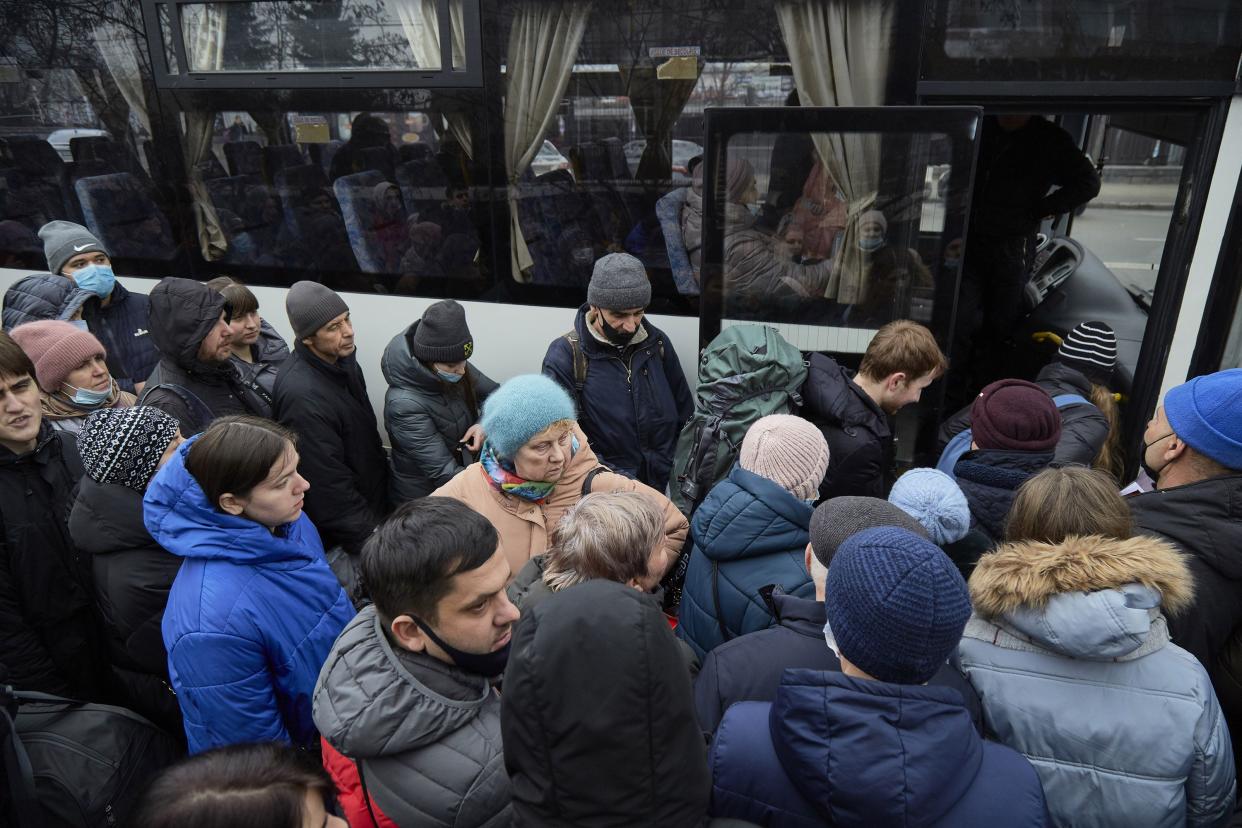 People board a bus as they attempt to evacuate the city on Feb. 24, 2022, in Kyiv, Ukraine. Overnight, Russia began a large-scale attack on Ukraine, with explosions reported in multiple cities and far outside the restive eastern regions held by Russian-backed rebels.