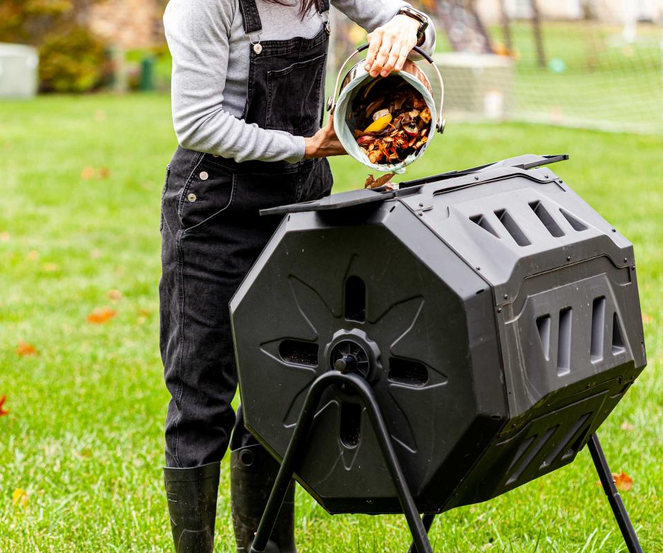 adding kitchen scraps to compost bin