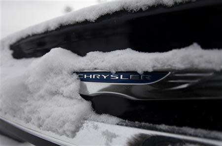 Snow surrounds the Chrysler logo displayed on a vehicle in the parking lot at Bill Snethkamp dealership in Detroit, Michigan January 2, 2014. REUTERS/Joshua Lott