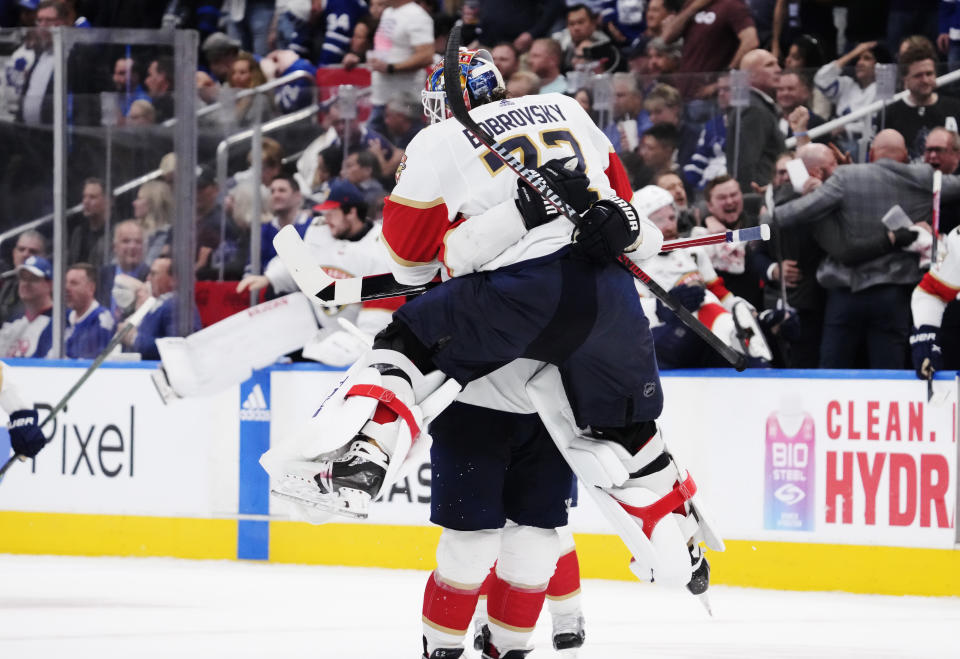 Florida Panthers goaltender Sergei Bobrovsky (72) and defenseman Brandon Montour (62) celebrate after defeating the Toronto Maple Leafs in overtime of Game 5 of an NHL hockey Stanley Cup second-round playoff series Friday, May 12, 2023, in Toronto. (Frank Gunn/The Canadian Press via AP)