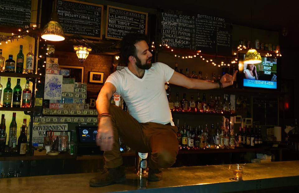 Kenneth John Jimenez, 36, working at a bar in Brooklyn, New York, where he made $9 an hour plus tips. Now he's getting $600 a week in pandemic unemployment assistance plus about $300 a week in regular jobless benefits. (Photo: Arber Muric)