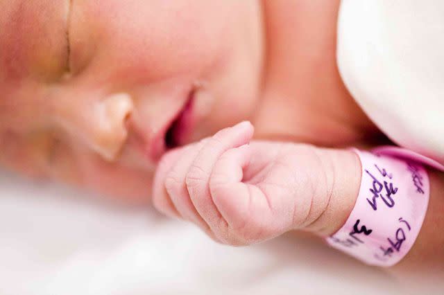 Getty / TongRo Images Stock image of newborn baby wearing hospital bracelet