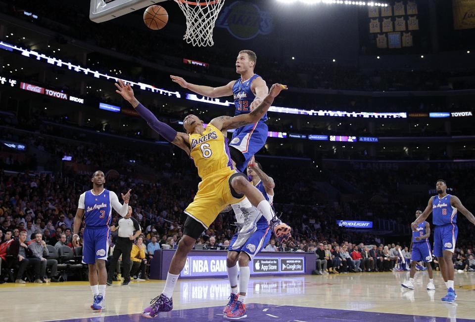 Los Angeles Clippers' Blake Griffin, top, fouls Los Angeles Lakers' Kent Bazemore during the first half of an NBA basketball game on Thursday, March 6, 2014, in Los Angeles. (AP Photo/Jae C. Hong)