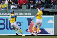 Boston Red Sox's Wilyer Abreu, right, makes a catch beside Ceddanne Rafaela, left, on a flyout by Los Angeles Angels' Taylor Ward during the fifth inning of a baseball game, Saturday, April 13, 2024, in Boston. (AP Photo/Michael Dwyer)