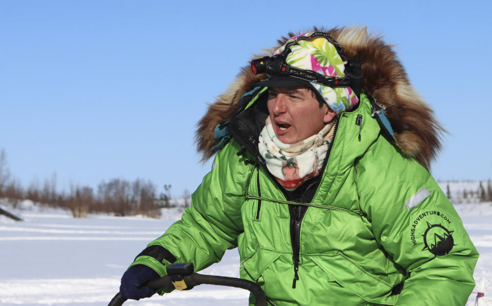 FILE - Ryan Redington heads out after stopping briefly at the Iditarod checkpoint of the Iditarod Trail Sled Dog Race on March 11, 2021. The winner of the Iditarod Trail Sled Dog Race pockets only about $50,000, but the real prize is a bronze statue of race co-founder Joe Redington Sr. embracing a sled dog under the iconic burled arch finish line. Ever since the first grueling Iditarod race across the Alaska wilderness, mushers with the last name Redington have lined up 71 times to win that trophy. (Zachariah Hughes/Anchorage Daily News via AP, Pool, File)