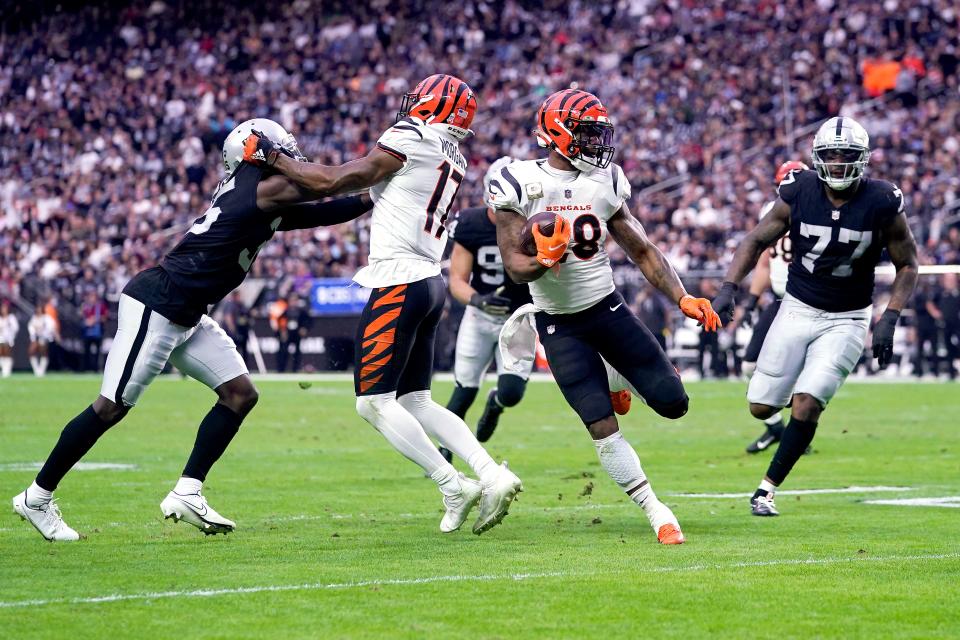 Cincinnati Bengals running back Joe Mixon (28) carries the ball on a touchdown run as Cincinnati Bengals wide receiver Stanley Morgan (17) blocks in the second quarter during a NFL Week 11 game, Sunday, Nov. 21, 2021, at Allegiant Stadium in Las Vegas.