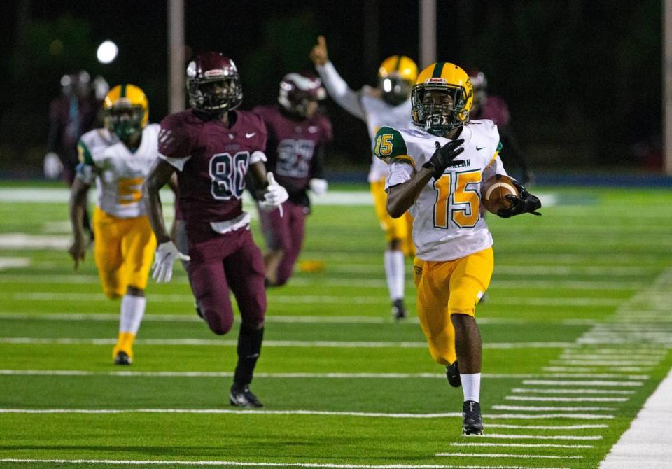 Killian Cougars wide receiver Javon Robinson (15) runs for a touchdown after intercepting a pass by quarterback Norland Vikings Khalil Anglinin the first quarter of a high school football game at Nathaniel Traz Powell Stadium on Thursday, October 29, 2020, in Miami.