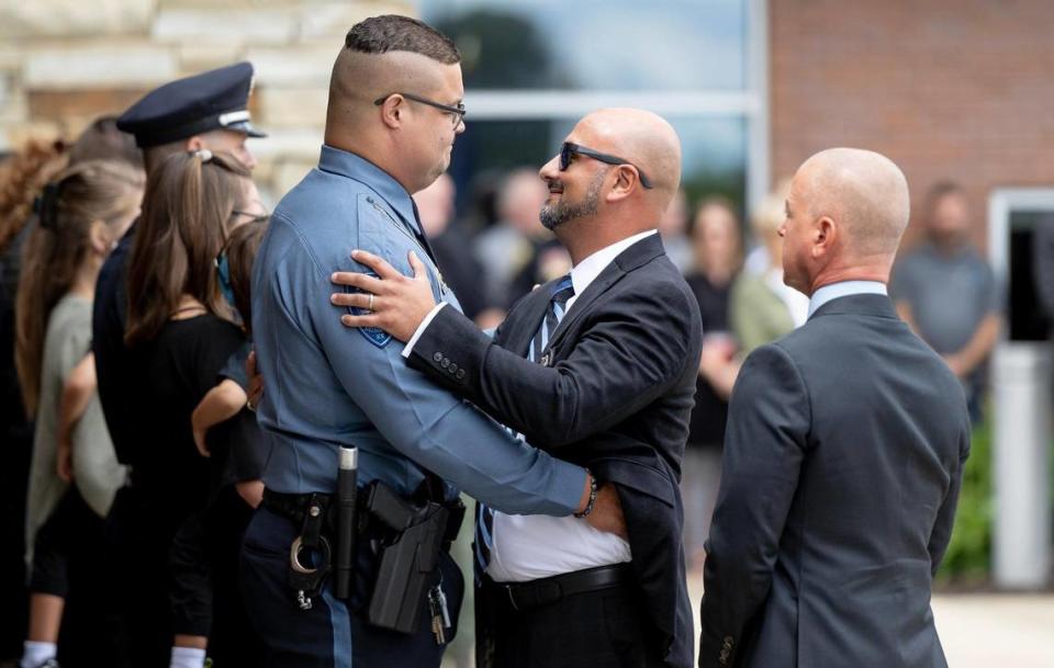 Mission police officer Victor Buitrago, a friend of fallen Fairway police officer Jonah Oswald, is greeted by fellow law enforcement officers following a funeral at Westside Family Church on Monday in Lenexa. Buitrago spoke during the ceremony about how his relationship with Oswald blossomed into one of the “greatest friendships I’ve ever experienced.”